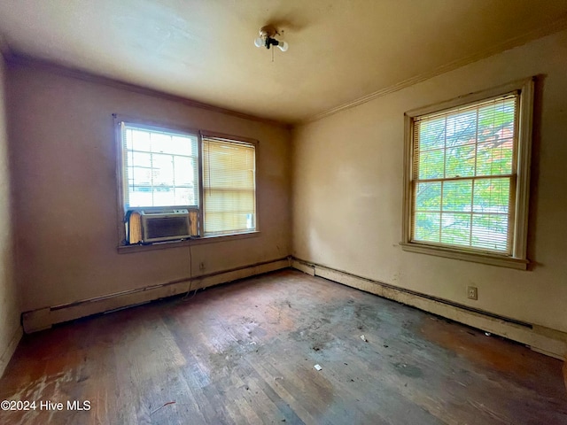 unfurnished room with cooling unit, hardwood / wood-style floors, plenty of natural light, and crown molding