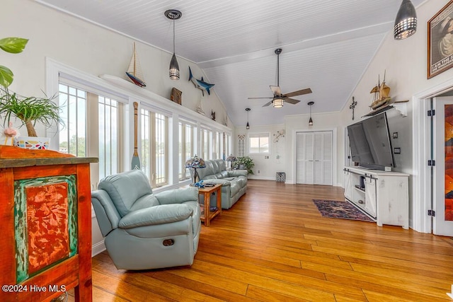 living area featuring light wood-style flooring, high vaulted ceiling, and a ceiling fan