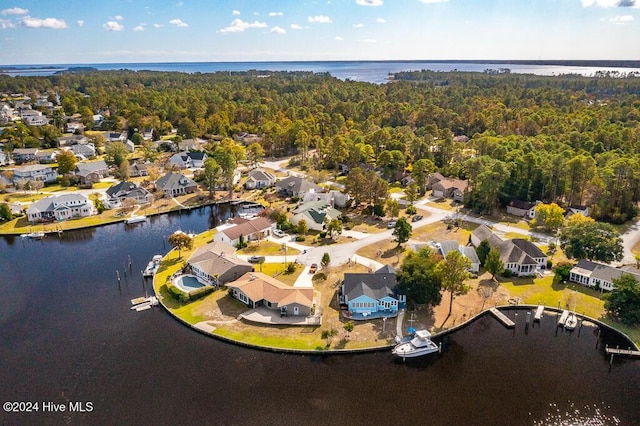 aerial view with a residential view, a water view, and a view of trees