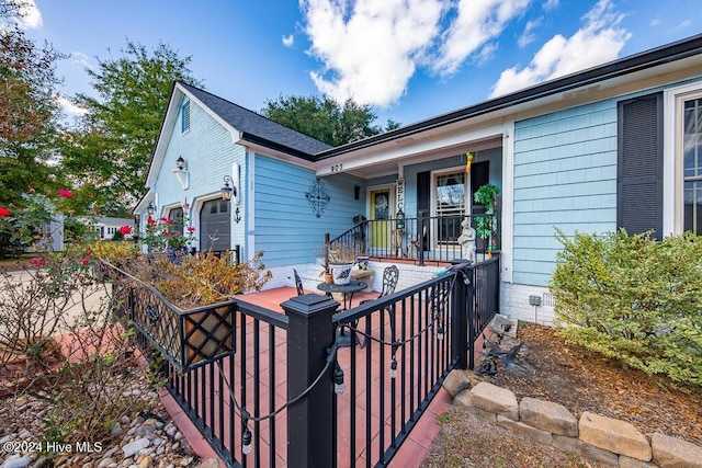 view of front facade featuring an attached garage and covered porch