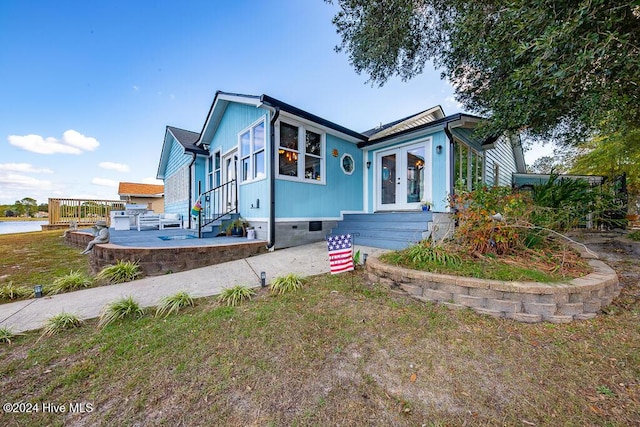 view of front of property featuring crawl space, entry steps, a patio, and french doors