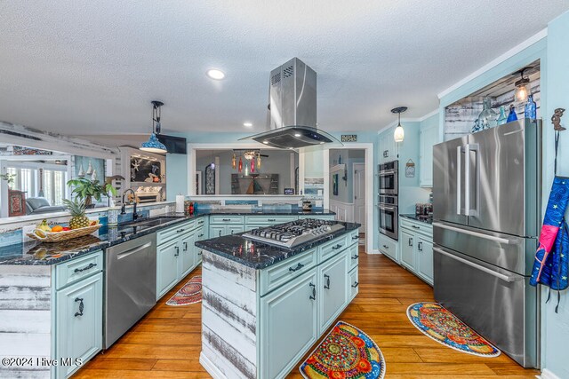 kitchen featuring a center island, stainless steel appliances, a sink, island range hood, and light wood-type flooring