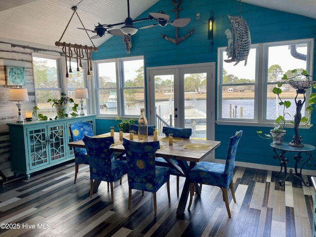 sunroom with a ceiling fan, lofted ceiling, french doors, and a water view