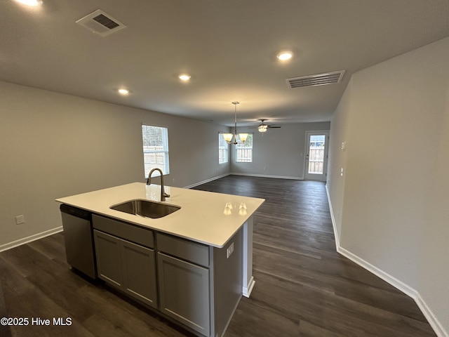 kitchen featuring stainless steel dishwasher, gray cabinetry, ceiling fan, sink, and a center island with sink