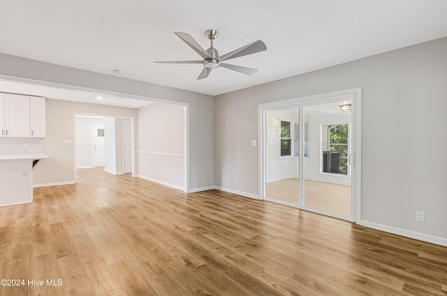 unfurnished living room featuring light hardwood / wood-style flooring and ceiling fan