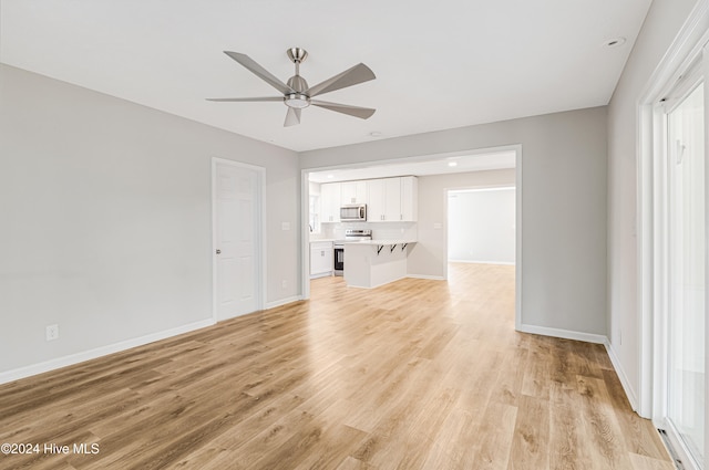 unfurnished living room with light hardwood / wood-style floors and ceiling fan