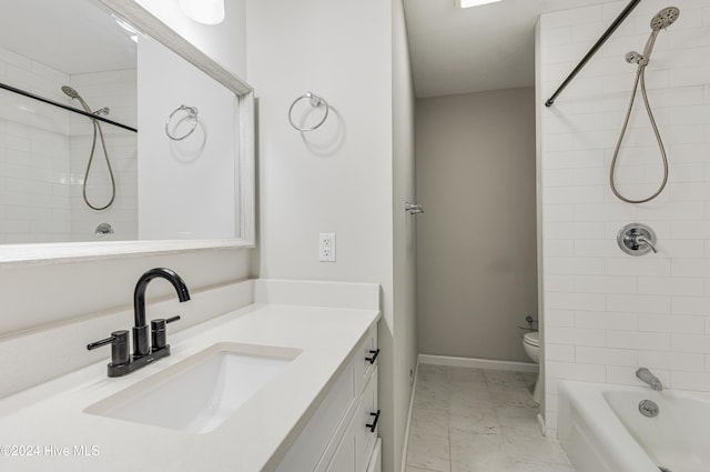 full bathroom featuring tiled shower / bath, vanity, and toilet