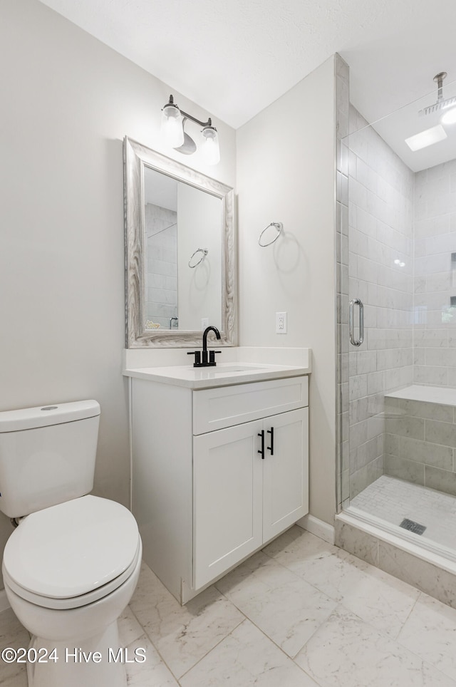 bathroom with toilet, a shower with shower door, and vanity