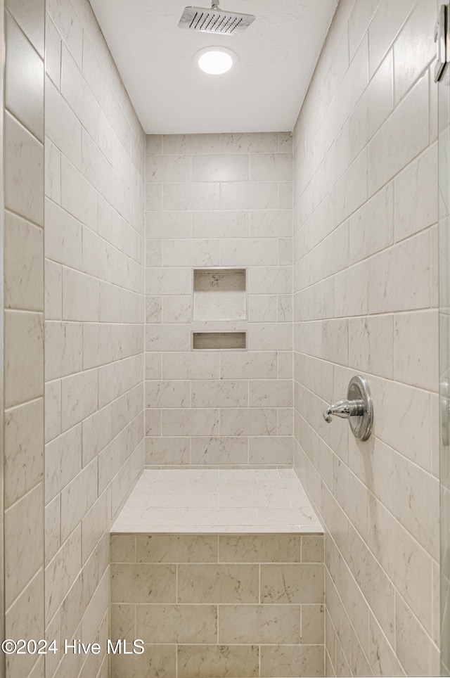 bathroom with a tile shower