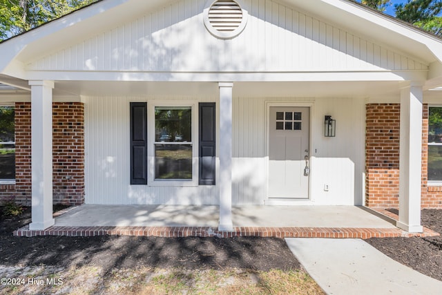 doorway to property with a porch