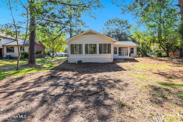 back of property with cooling unit and a sunroom