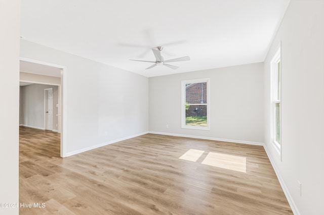 unfurnished room featuring light hardwood / wood-style floors and ceiling fan