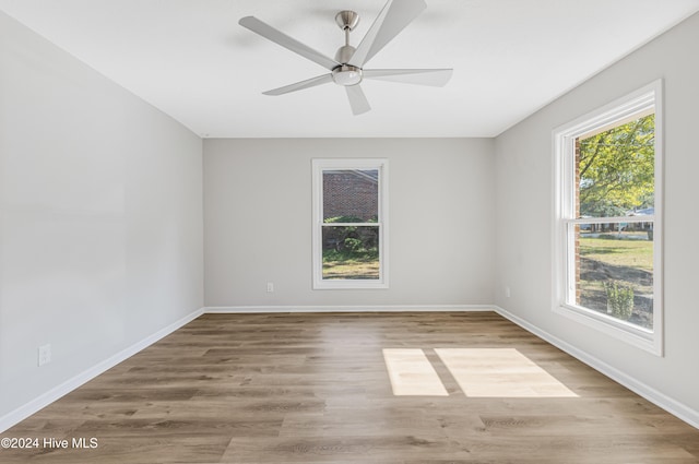 empty room featuring light wood-type flooring and ceiling fan