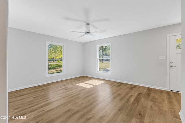 empty room featuring light wood-type flooring and ceiling fan