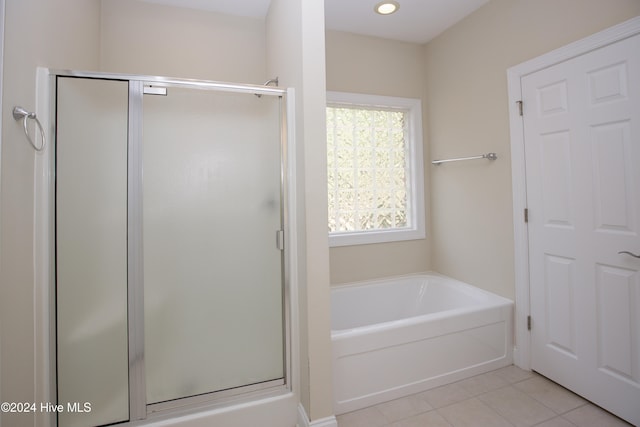 bathroom with independent shower and bath and tile patterned flooring