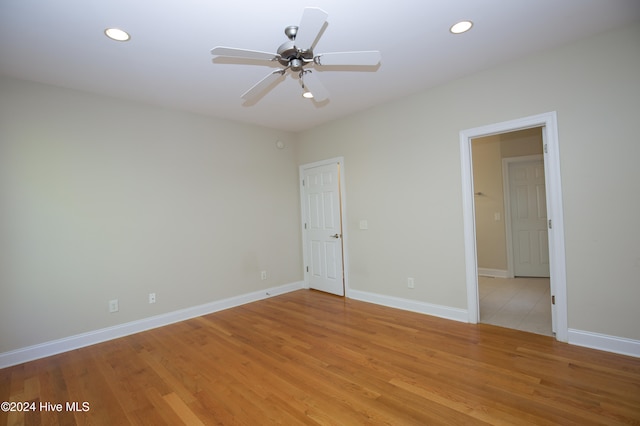 spare room featuring light hardwood / wood-style floors and ceiling fan