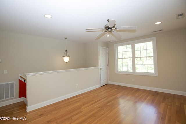 spare room featuring ceiling fan and hardwood / wood-style floors