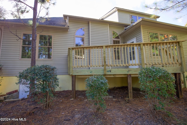 rear view of property with a wooden deck