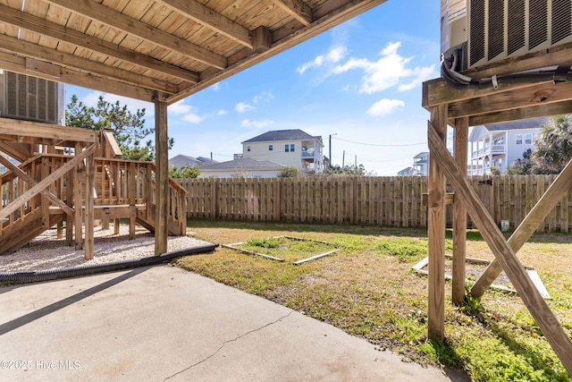 view of yard featuring a fenced backyard, a patio, and a playground