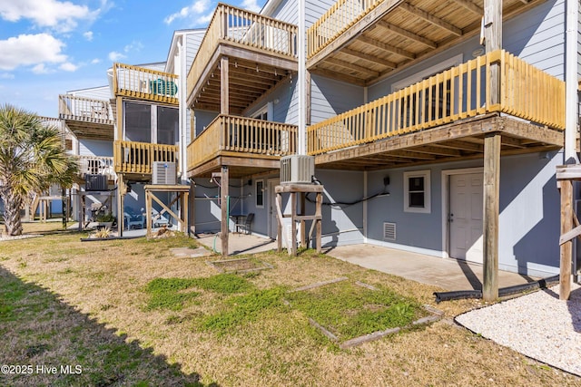 back of house with a lawn and a patio area