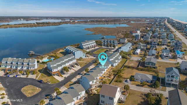 drone / aerial view with a water view and a residential view