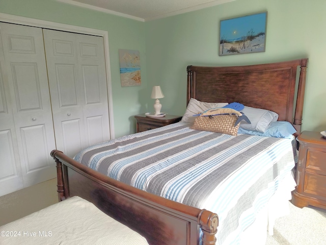 carpeted bedroom featuring a closet