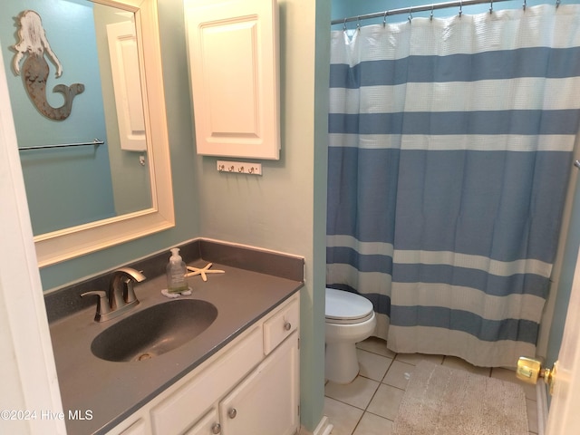 bathroom featuring vanity, a shower with shower curtain, toilet, and tile patterned floors