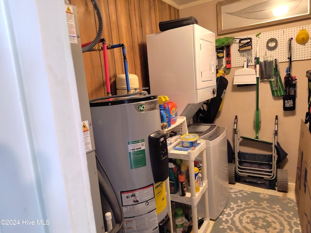 interior space featuring water heater and stacked washer / dryer