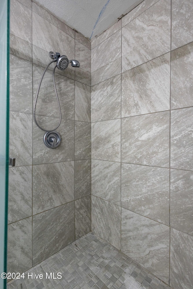 bathroom with a tile shower