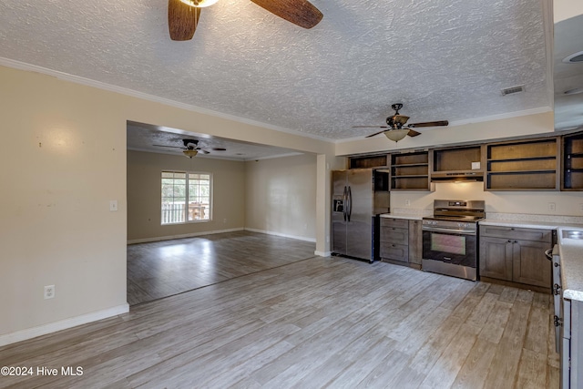 kitchen with ornamental molding, light hardwood / wood-style floors, a textured ceiling, and appliances with stainless steel finishes