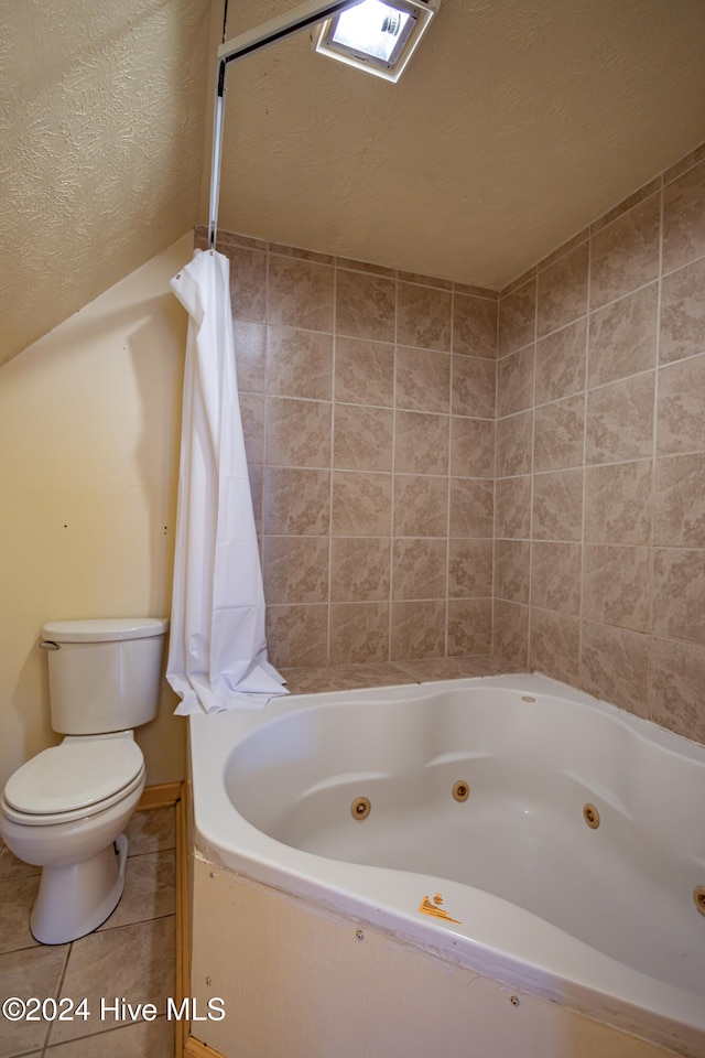 bathroom featuring tile patterned floors, a textured ceiling, and toilet