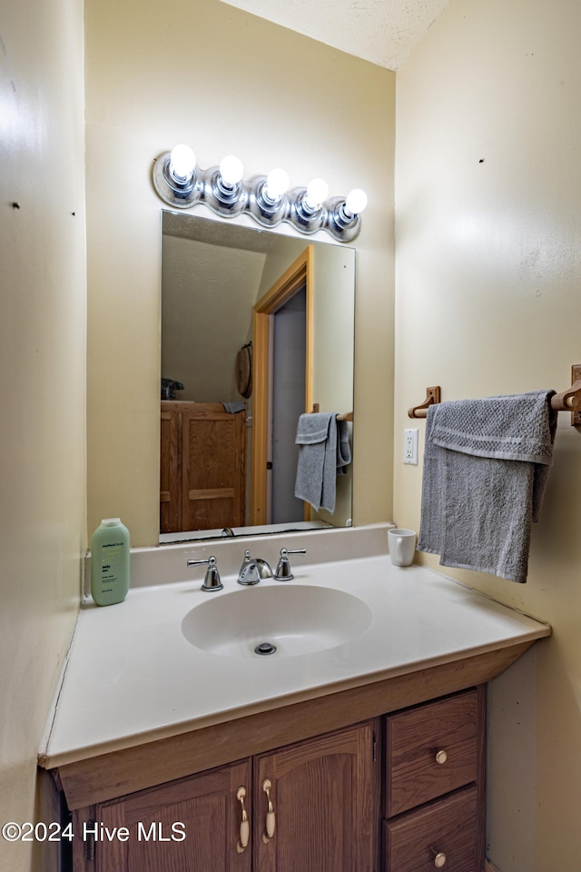 bathroom featuring vanity and a textured ceiling