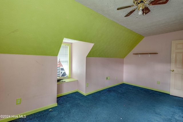 additional living space featuring carpet, ceiling fan, lofted ceiling, and a textured ceiling