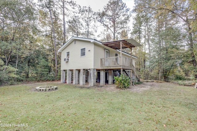 back of house featuring a lawn and a wooden deck