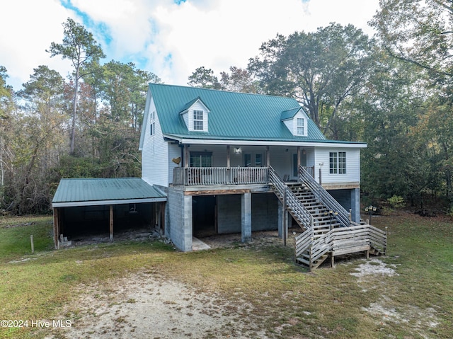 view of front of home featuring covered porch and a front lawn