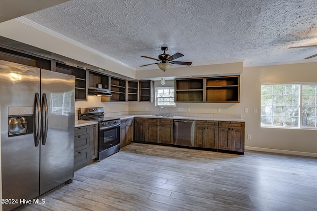 kitchen featuring light hardwood / wood-style floors, a textured ceiling, and appliances with stainless steel finishes