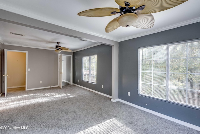 unfurnished bedroom featuring light colored carpet, ceiling fan, and ornamental molding