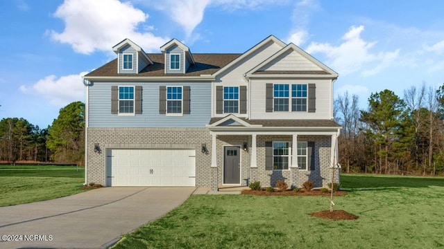 3057 Platinum Cir W, End, NC 27376 - view of front of house featuring driveway, a front lawn, brick siding, and an attached garage