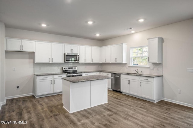 3057 Platinum Cir W, End, NC 27376 - kitchen with appliances with stainless steel finishes, a sink, white cabinetry, backsplash, and recessed lighting