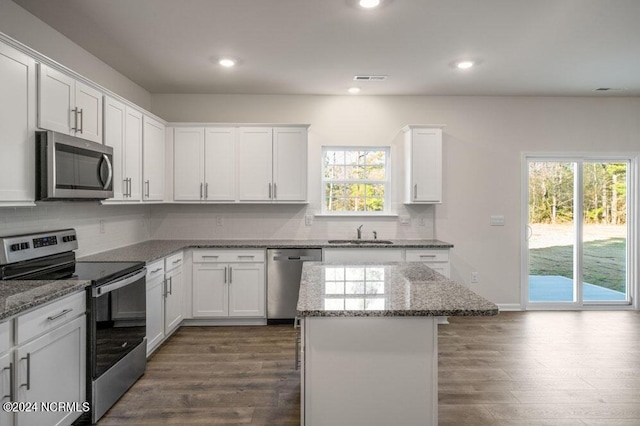 3057 Platinum Cir W, End, NC 27376 - kitchen with stainless steel appliances, a sink, tasteful backsplash, white cabinets, and dark wood finished floors
