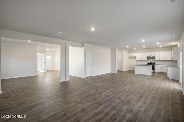 3057 Platinum Cir W, End, NC 27376 - unfurnished living room featuring recessed lighting, dark wood-type flooring, and baseboards