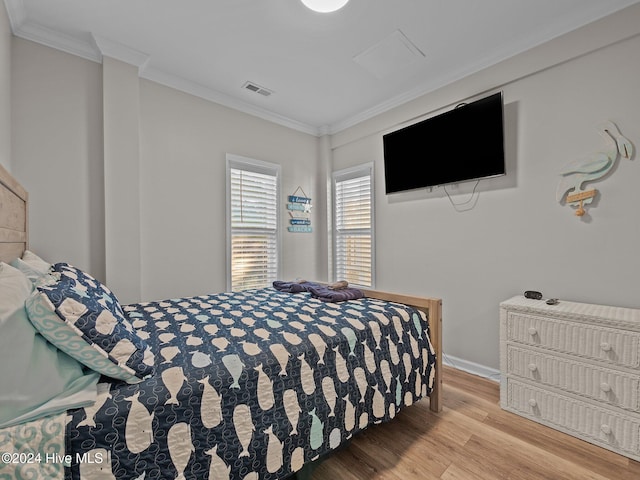 bedroom with wood-type flooring and ornamental molding