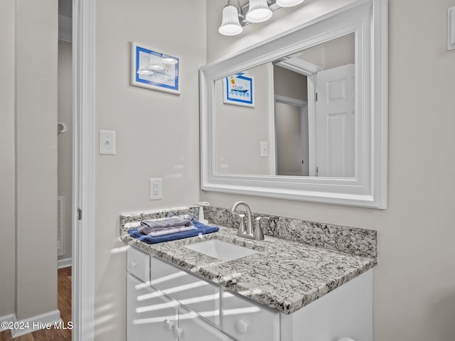 bathroom with vanity and hardwood / wood-style flooring