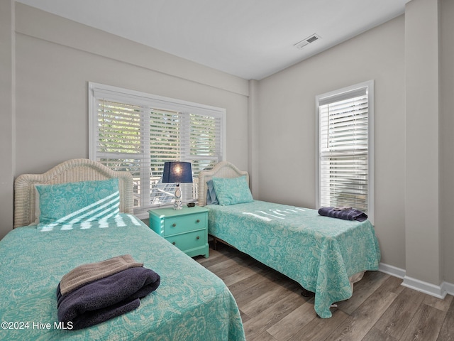 2610 Emerald Dr, Emerald Isle, NC 28594 - bedroom with multiple windows, wood finished floors, and baseboards