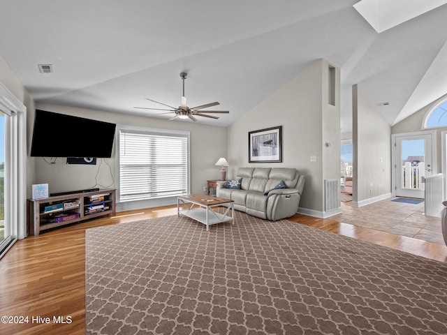 living room featuring high vaulted ceiling, ceiling fan, and light hardwood / wood-style flooring