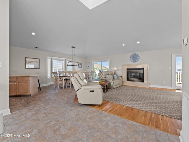 living room featuring light hardwood / wood-style flooring and a high end fireplace