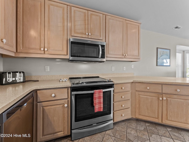 kitchen with light brown cabinets, kitchen peninsula, and appliances with stainless steel finishes