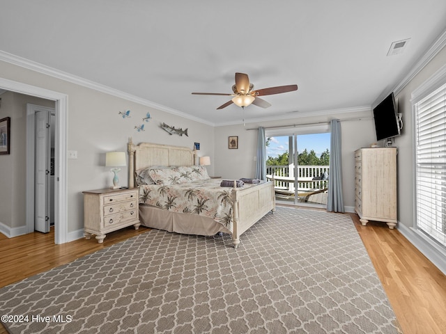 bedroom with light hardwood / wood-style floors, ceiling fan, and multiple windows