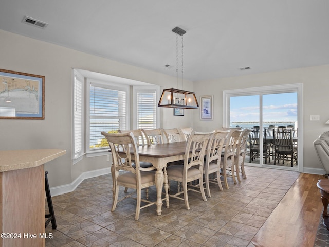 2610 Emerald Dr, Emerald Isle, NC 28594 - dining space featuring baseboards and a chandelier