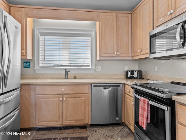 2610 Emerald Dr, Emerald Isle, NC 28594 - kitchen with stainless steel appliances, a sink, light brown cabinetry, and light countertops
